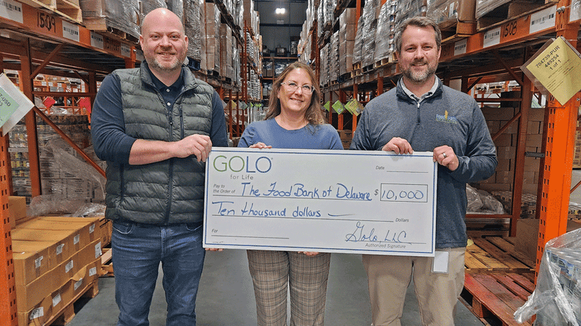 Jen Brooks presenting a check to the food bank of Delaware.