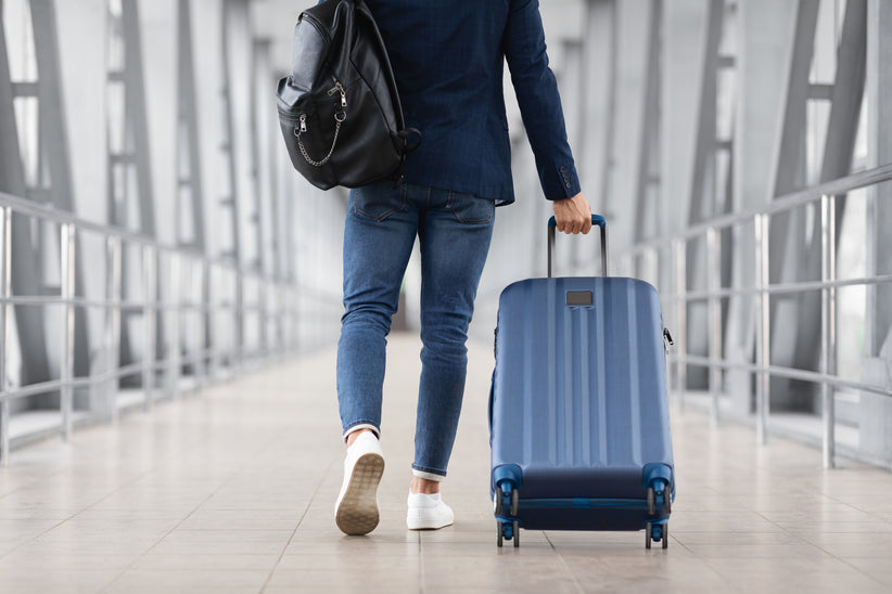 Person walking with a suitcase in an airport