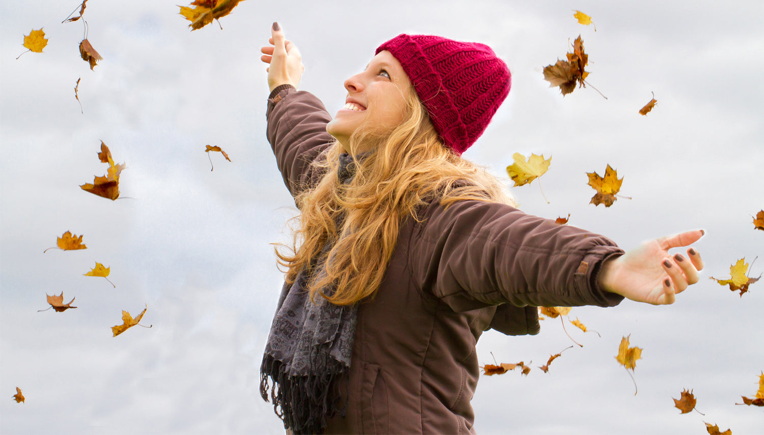 Woman playing in the autum leaves