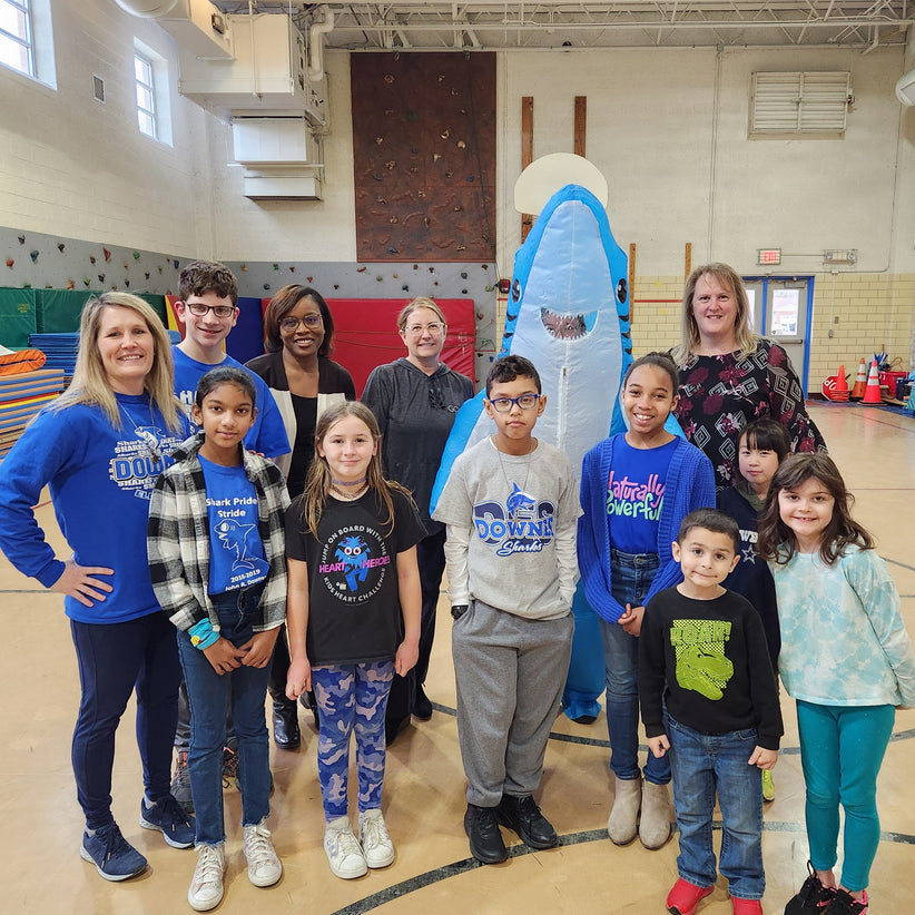 Group of students and teachers from John R. Downes Elementary School pose for a photo with Jen Brooks of GOLO and the school shark mascot. 