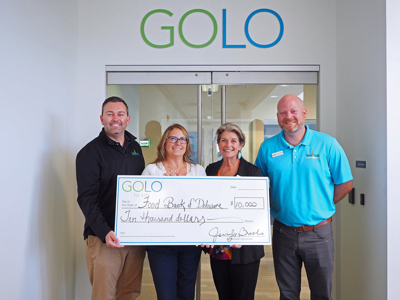 GOLO president Jennifer Brooks donating to Food Bank of Delaware at GOLO's corporate headquarters.