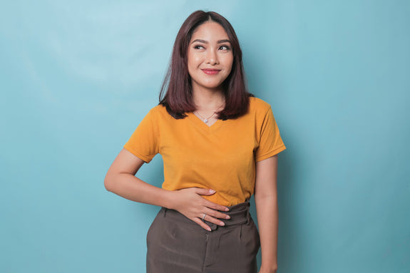 Woman who looks hungry holding her stomach