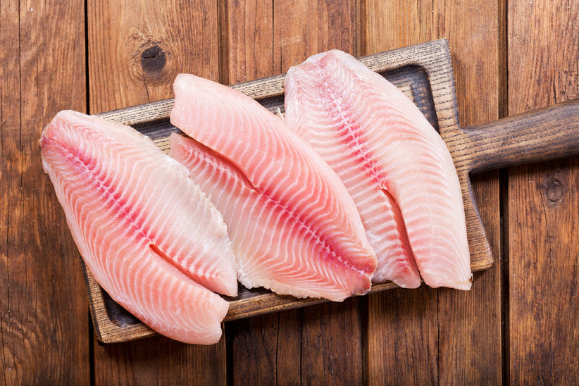 Fresh fish fillet on wooden board