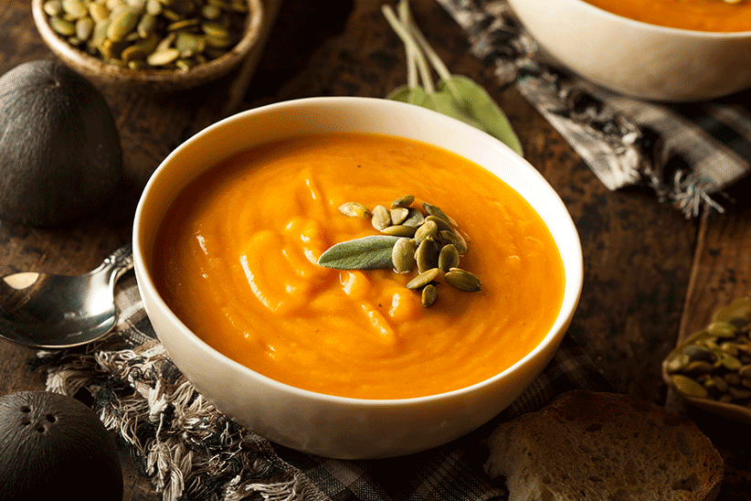 Bowl of butternut squash soup on a fall-themed table