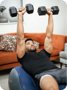 Fit man doing a dumbbell press while he works his core on the AeroTrainer