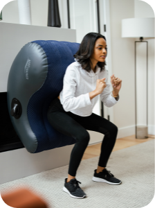 Young woman performing Wall Squats using the AeroTrainer to maintain perfect form