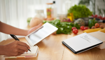 a person planning a meal in a cook book